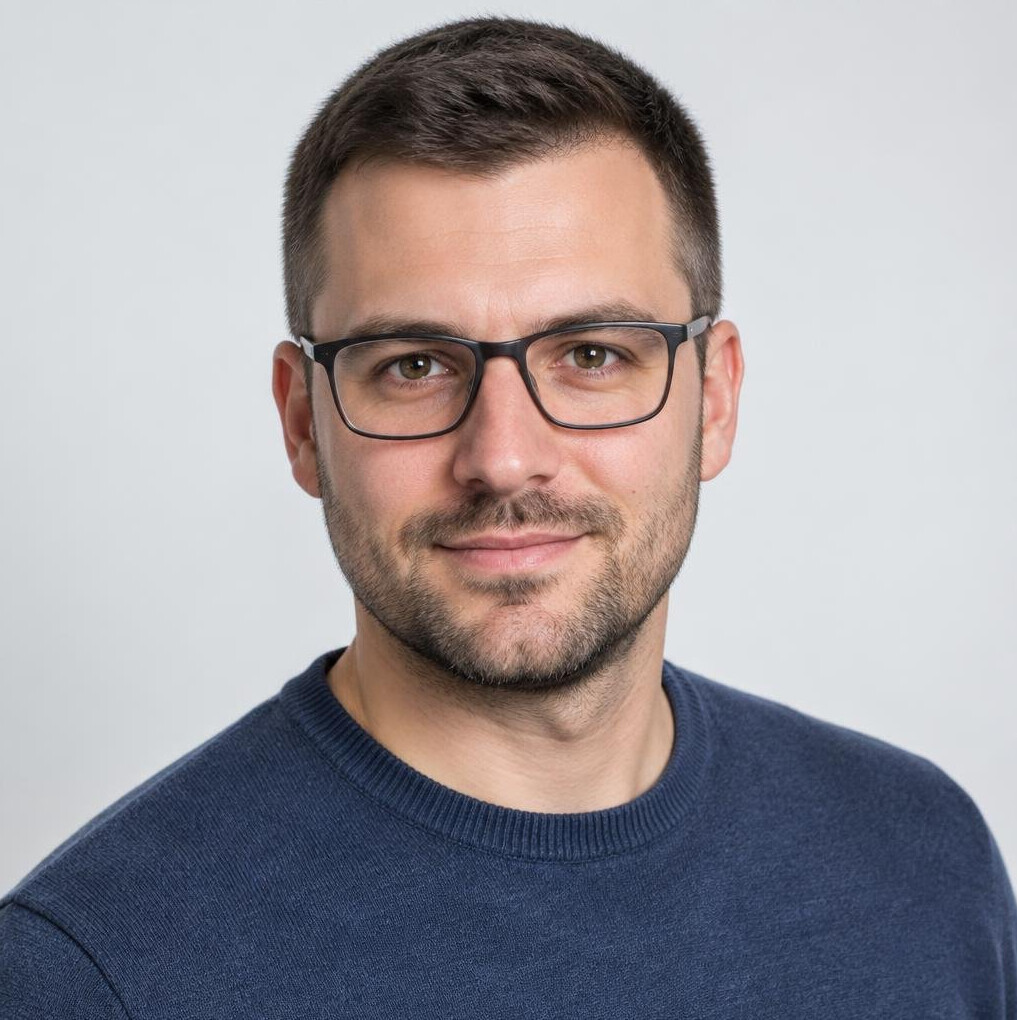 Studio portrait of a man with glasses